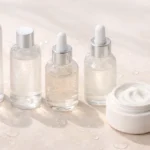 Korean skincare layering steps showing hydrating textures from watery toner to cream in a clean minimalist flat lay
